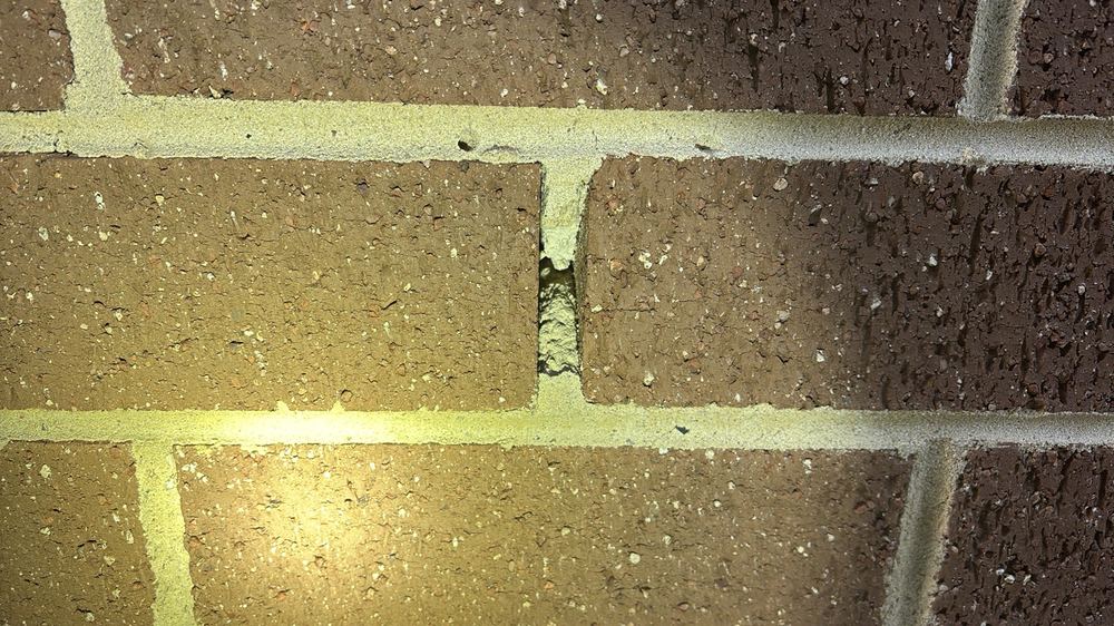 Weep holes blocked with mortar, trapping moisture in the cavity, found during a fixing stage inspection in Manor Lakes