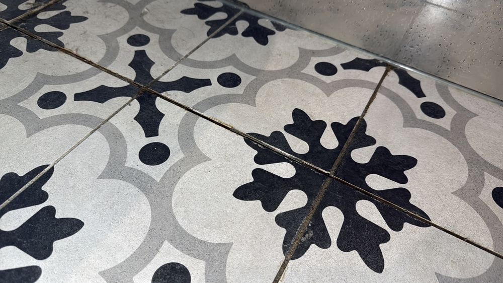 Floor tiles cracked across a room, found during a defect investigation inspection in Seddon