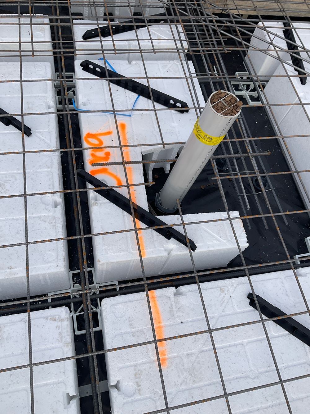 Trimmer bars missing around a penetration where the top mesh had been cut, found during a slab pre-pour inspection in Manor Lakes