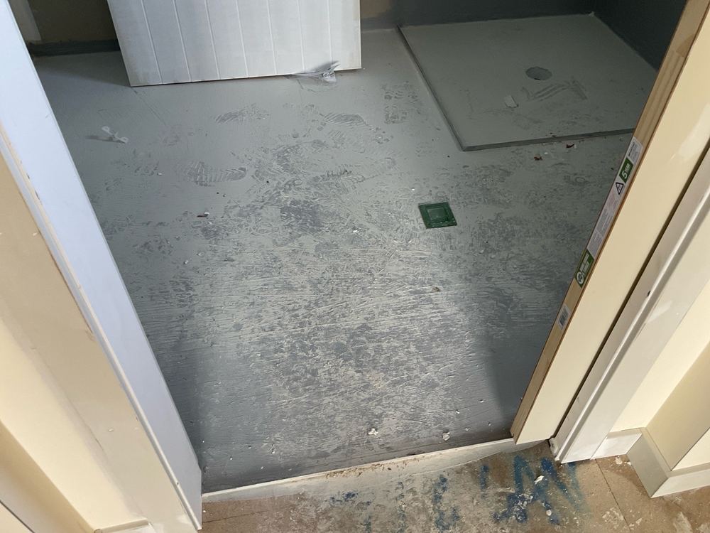 Membrane laid straight onto particleboard flooring in an upstairs wet area, found during a waterproofing stage inspection in Manor Lakes